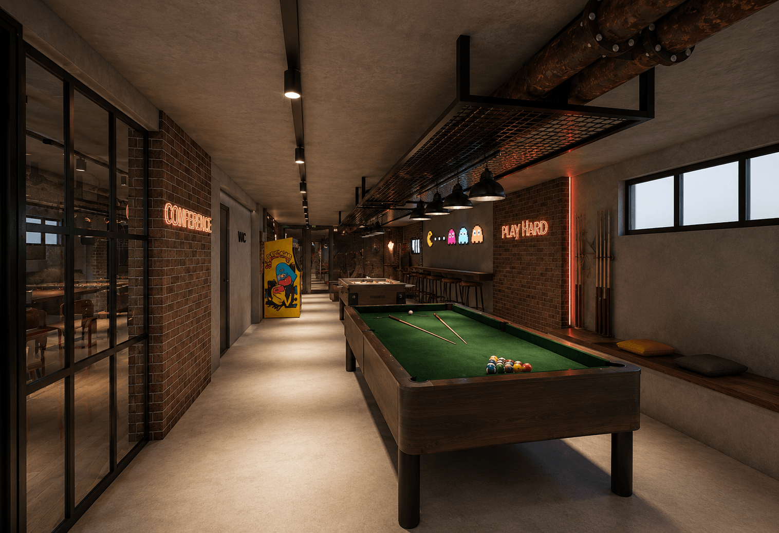 Games room at Campus42 — billiards table under 'play hard' neon and exposed brick.